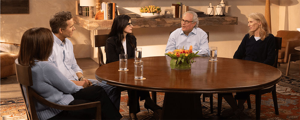 Ryan Reynolds at round table listening to someone living with Parkinson’s share his story